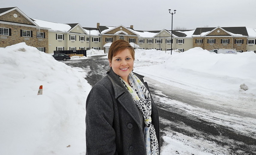 Bellavita executive director Melissa Craig stands near the senior apartment complex set to open this spring in Scarborough. The first Maine property of the nation’s largest senior housing developer will charge rents starting at $4,200 per month.