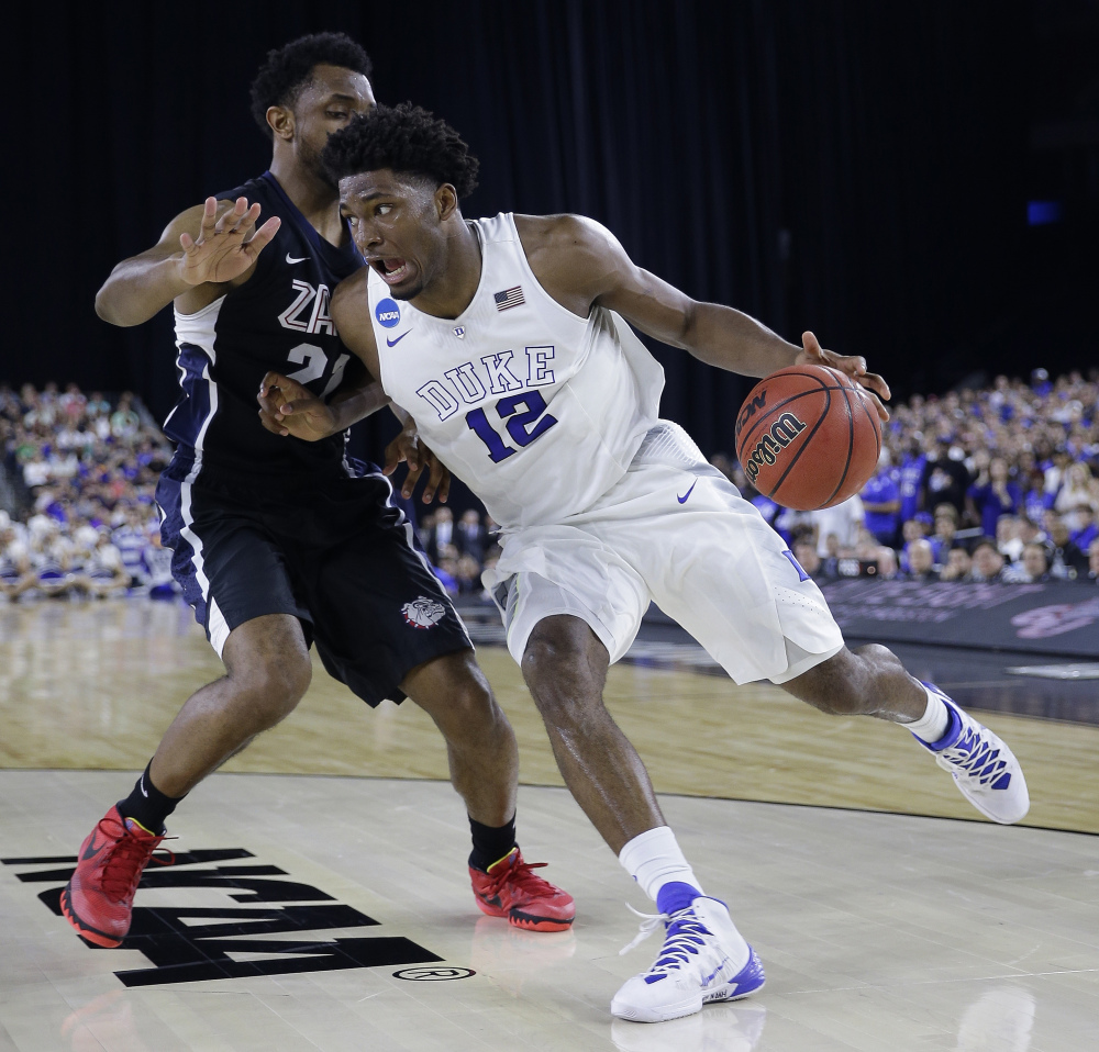 Duke’s Justise Winslow (12) tries to drive past Gonzaga’s Byron Wesley during the first half of a college basketball regional final game in the NCAA Tournament Sunday, in Houston.