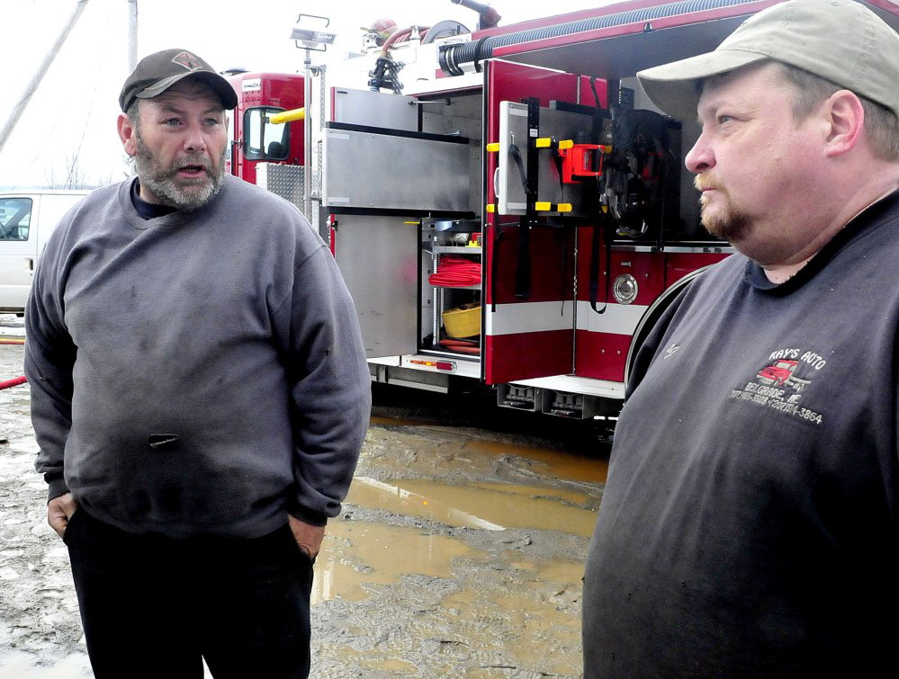 Owners Ray Frappier, left, and Percy French aren’t sure whether they will rebuild Ray’s Auto, which was destroyed by fire Monday.