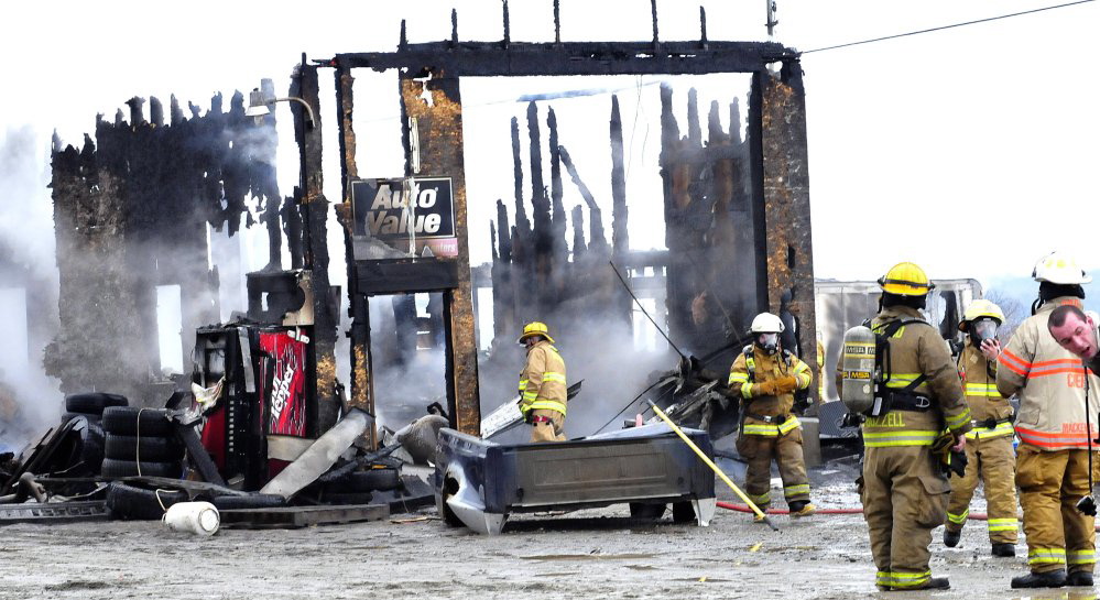 Firefighters put out a blaze that destroyed Ray’s Auto in Belgrade on Monday.