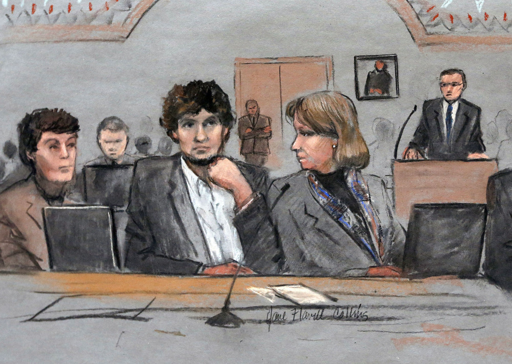 Dzhokhar Tsarnaev, center, is depicted between defense attorneys Miriam Conrad, left, and Judy Clarke, right, during his federal death penalty trial in Boston.