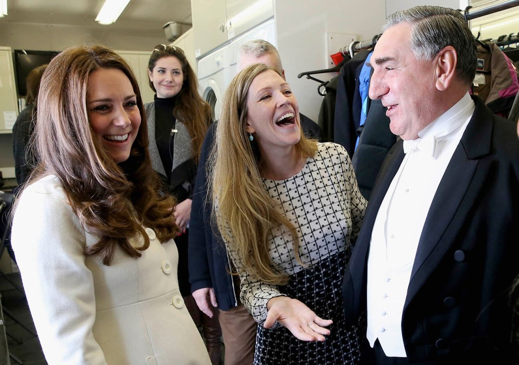 Britain's Kate  Duchess of Cambridge, left,  chats to actor Jim Carter,  who portrays the butler Carson, during a visit to the set of the TV series "Downton Abbey" at Ealing Studios in London on Thursday. The Associated Press