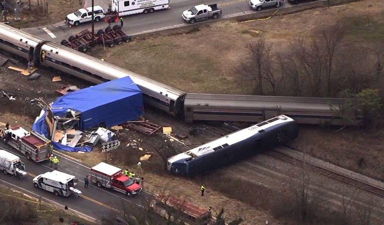In this frame grab from video provided by WTVD-11, authorities respond to a collision between an Amtrak passenger train and a truck Monday in Halifax County, N.C. 