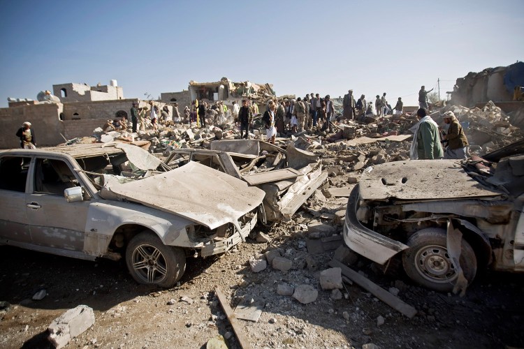 People search for survivors under the rubble of houses destroyed by Saudi airstrikes  near Sanaa Airport, Yemen. Saudi Arabia launched airstrikes Thursday targeting military installations in Yemen held by Shiite rebels who were taking over a key port city in the country's south and had driven the embattled president to flee by sea, security officials said.