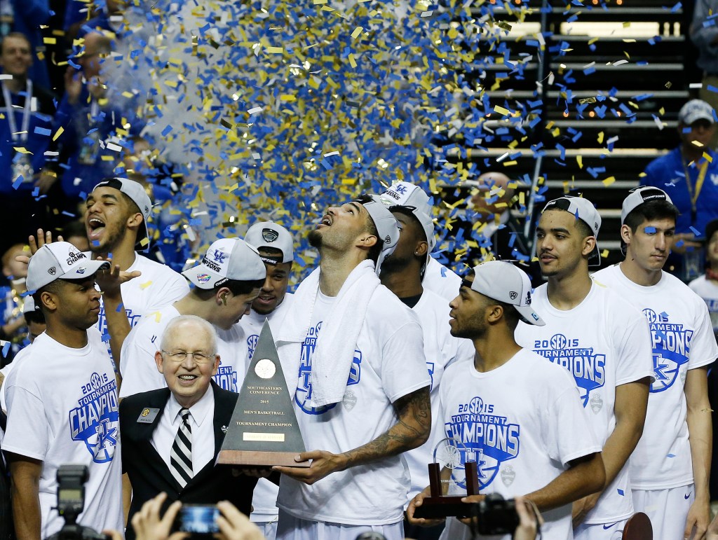Kentucky forward Willie Cauley-Stein holds the trophy after the NCAA college basketball Southeastern Conference tournament championship game against Arkansas on Sunday. Kentucky goes into the NCAA Tournament undefeated. The Associated Press