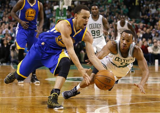 Golden State Warriors guard Stephen Curry beats Boston Celtics guard Avery Bradley to a loose ball in the second half of the Warriors' 106-101 win in Boston on Sunday. The Associated Press