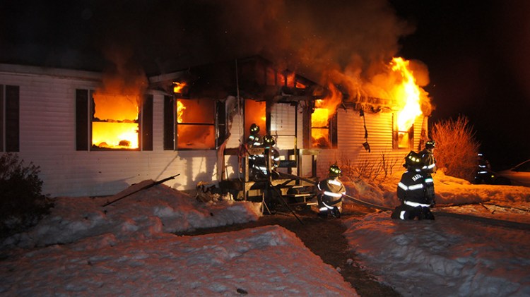 Firefighters battle a mobile home fire on Plains Road in Harrison early Friday morning.