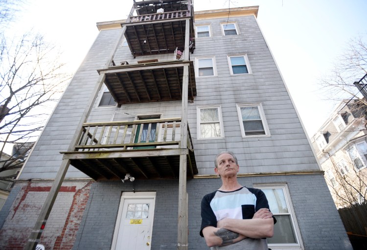 Bert Stain stands in the backyard of 563 Cumberland Ave. on Thursday, where his brother Donald Stain died after falling from the third-floor porch the day before. 