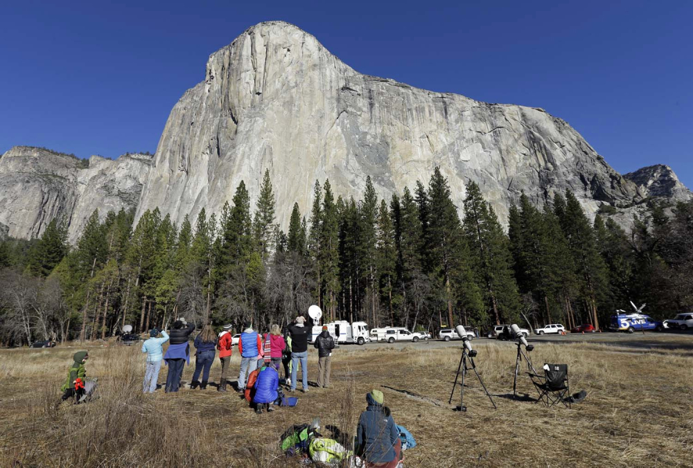 Spectators gaze at El Capitan in Yosemite National Park in California, where fees will increase this summer.
