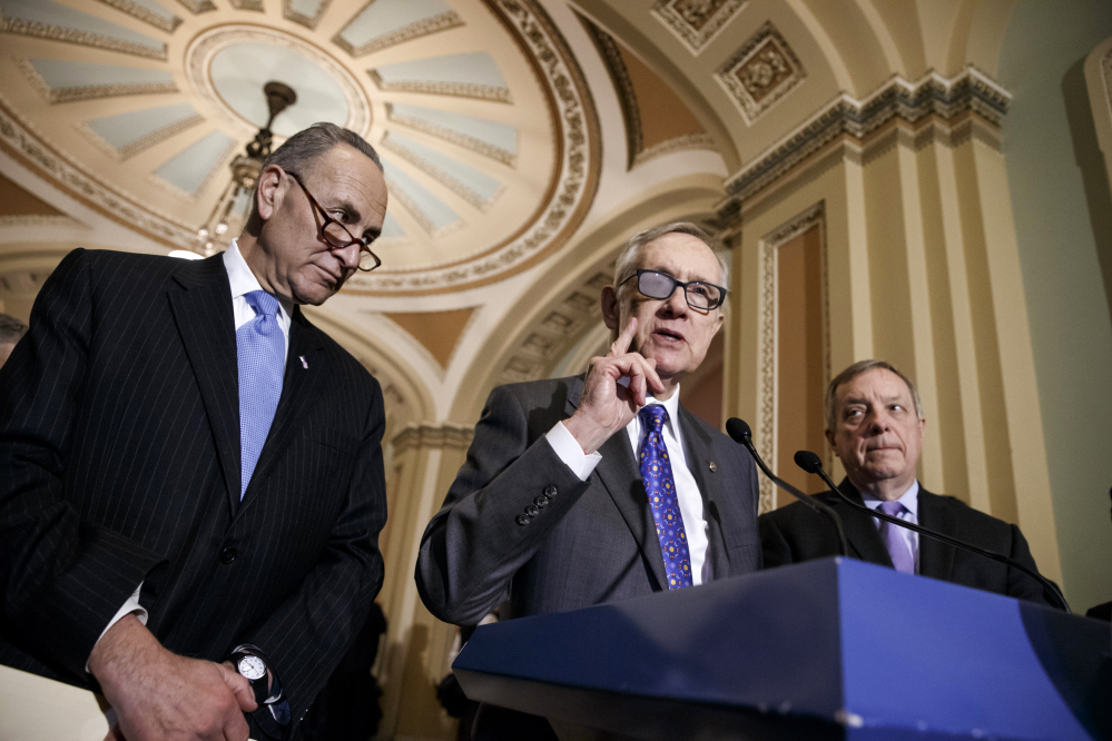 Senate Minority Leader Harry Reid, flanked by Sen. Charles Schumer, left, and Senate Minority Whip Richard Durbin at a news conference March 3, said Wednesday that he will not take sides in a dispute over who will fill the Democratic Senate leadership posts when he retires in two years.