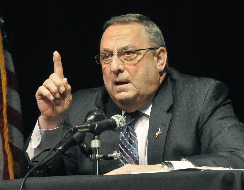 Gov. Paul LePage discusses his tax reform plan at a town hall forum in Saco on Thursday night. The session came to a halt after a vocal disturbance by Joanne Twomey.