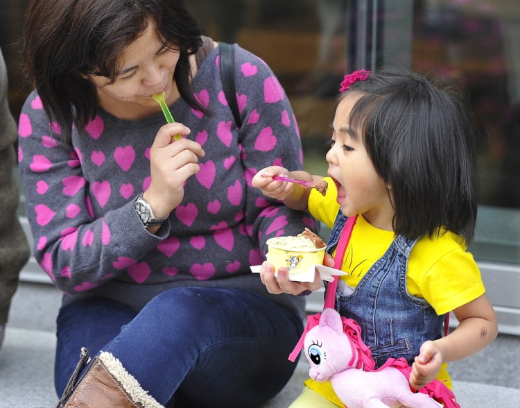 Gordon Chibroski/Staff Photographer
Lisa Chang and her daughter Erin Chang, 3, enjoy Friday’s warm weather in Portland by eating pistachio and chocolate gelato from Gorgeous Gelato on Fore Street. They came from Skowhegan, where they live, with family members for a couple of days to enjoy the Portland area, and the weather was a bonus.