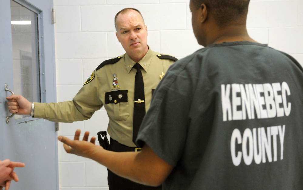 Kennebec County Sheriff Randy Liberty confers with an inmate Thursday at the Kennebec County Correctional Facility in Augusta. He has asked local police departments to use discretion in arresting people accused of minor nonviolent offenses – people who may be in jail simply because they lack bail. The jail regularly exceeds the 147 inmates authorized by the state.