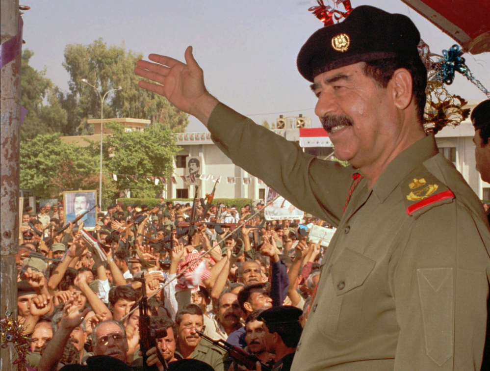 Saddam Hussein waves to supporters in Baghdad in 1995.