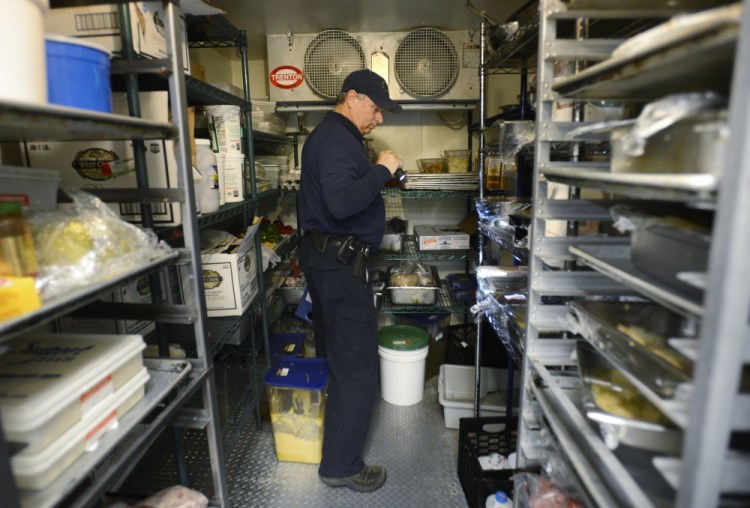 Scott Davis, a health inspector with the state of Maine, inspects a restaurant in York in 2013. The Legislature’s Health and Human Services Committee is scheduled to hold a public hearing Monday on a bill to increase the number of health inspectors, with a goal of reaching all restaurants on an annual basis.