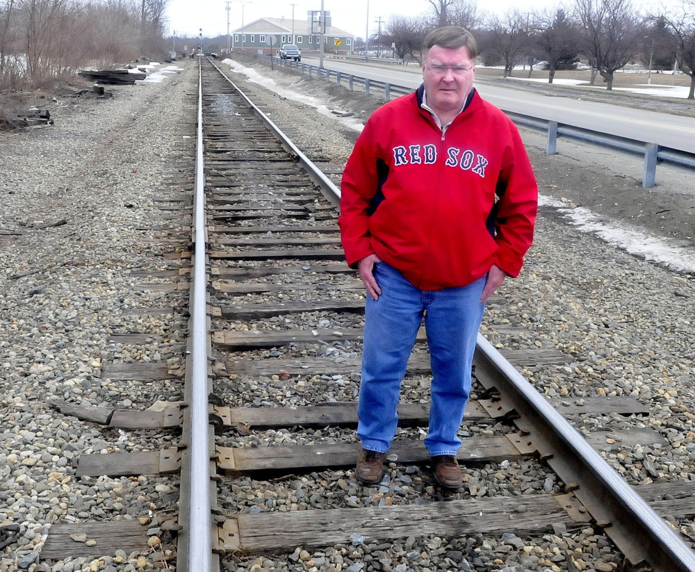 City Council Chairman Fred Stubbert, seen on the tracks along Colby Street, agrees with Sydney Mayhew that restoring train service to Waterville is worth pursuing.