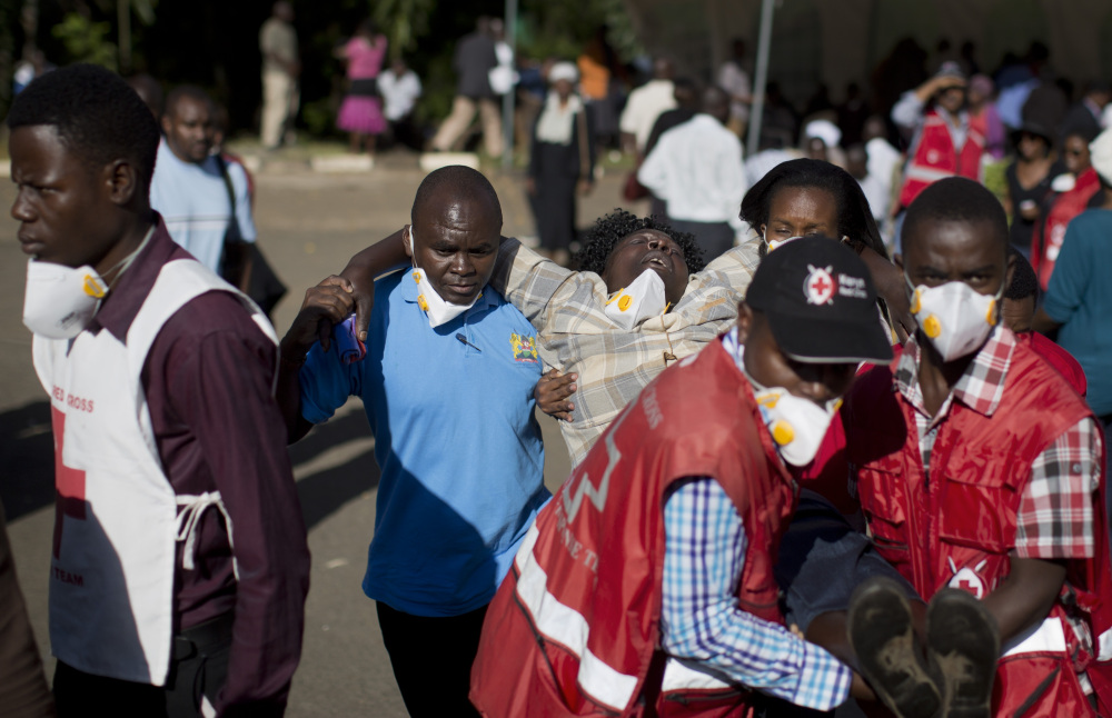 A grief-stricken relative, center, is carried Monday by Red Cross workers in Nairobi, Kenya, after identifying the body of one of those killed Thursday in the attack on a college in Garissa. Al-Shabab militants had claimed responsibility for the attack.