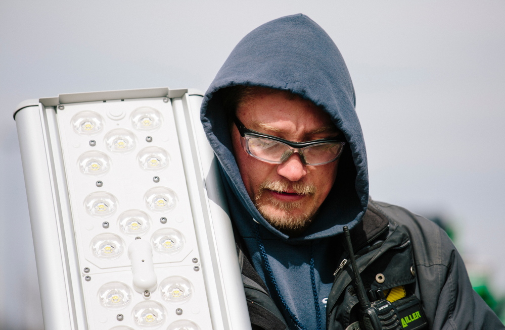Nick Dyro holds a replacement LED light panel. Over the last year or so, LED prices have been falling fast.