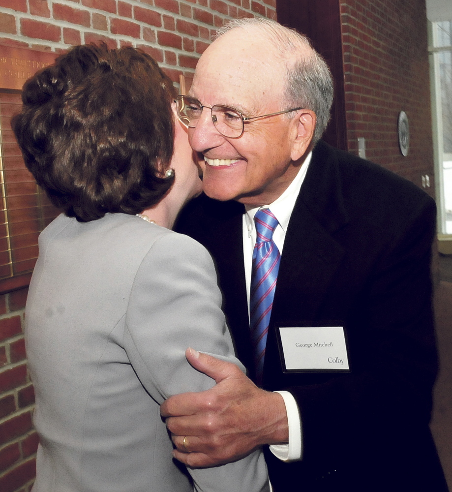 Former Sen. George Mitchell hugs U.S. Sen. Susan Collins before she delivers the annual Mitchell lecture at Colby College in Waterville on Thursday.