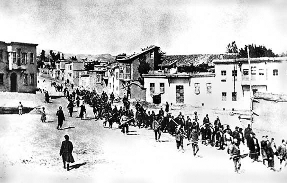 Turkish soldiers march Armenians through a village in 1915.