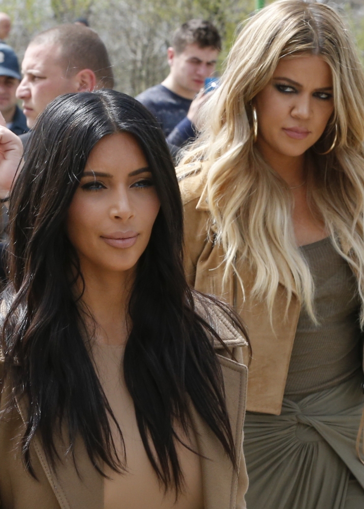 Kim Kardashian, left, and sister Khloe walk in Victory Park while filming in Yerevan, Armenia, on Thursday.
