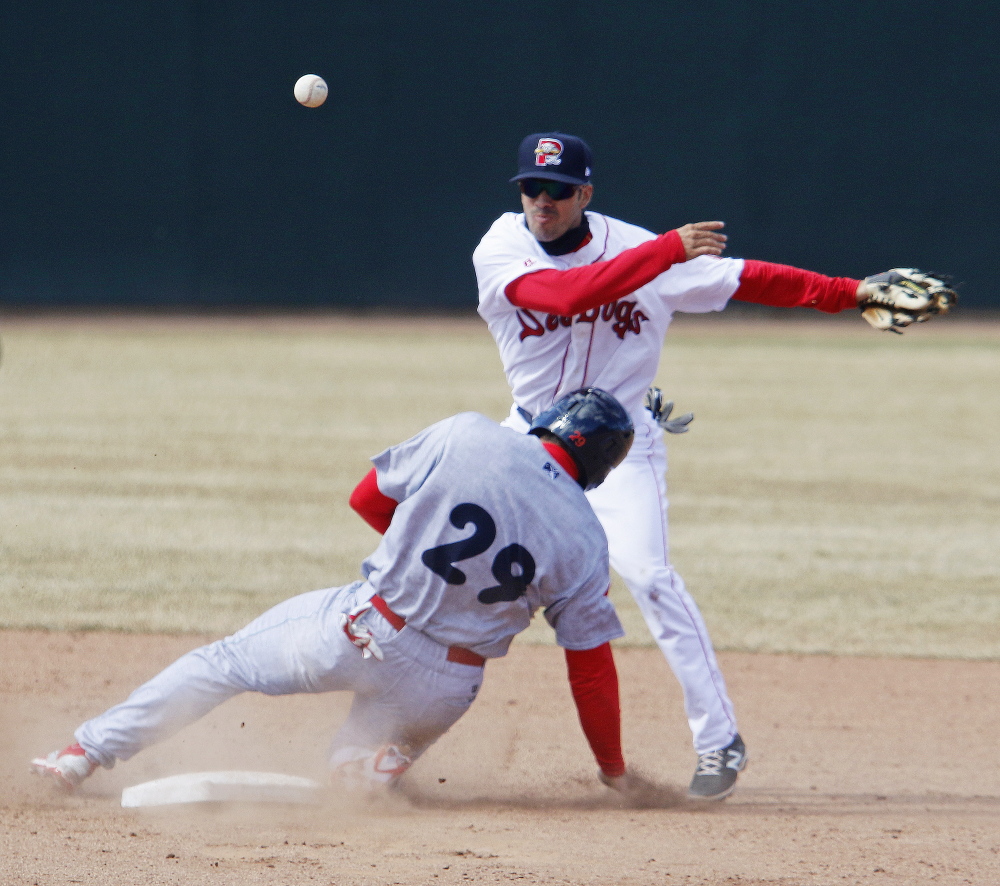 Portland’s Carlos Asuaje throws to first after tagging out Reading’s Brian Pointer at second base on Opening Day at Hadlock Field in Portland.