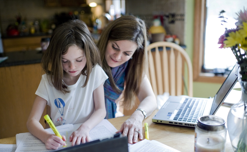 Kelly Howard works with her 7-year-old daughter Zoey, who has dyslexia, at their home in New Hartford, Conn. Legislation that went into effect in January adds a checkbox for dyslexia under students’ individualized education plans, a step parents say will help schools focus on the disorder.
