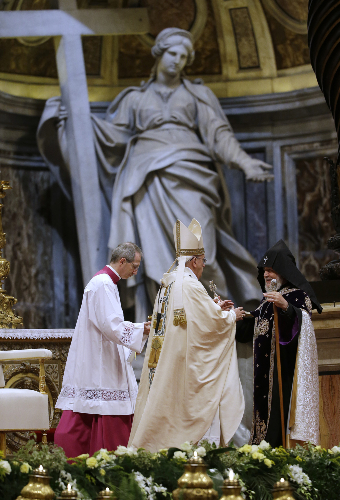 Pope Francis, center, is greeted by the head of Armenia's Orthodox Church Karekin II, right, during an Armenian-Rite Mass  in St. Peter's Basilica, at the Vatican, Sunday, April 12, 2015. Pope Francis on Sunday called the slaughter of Armenians by Ottoman Turks "the first genocide of the 20th century" and urged the international community to recognize it as such, sparking a diplomatic rift with Turkey. Turkey, which has long denied a genocide took place, immediately summoned the Vatican ambassador to complain and promised a fuller official response. (AP Photo/Gregorio Borgia)
