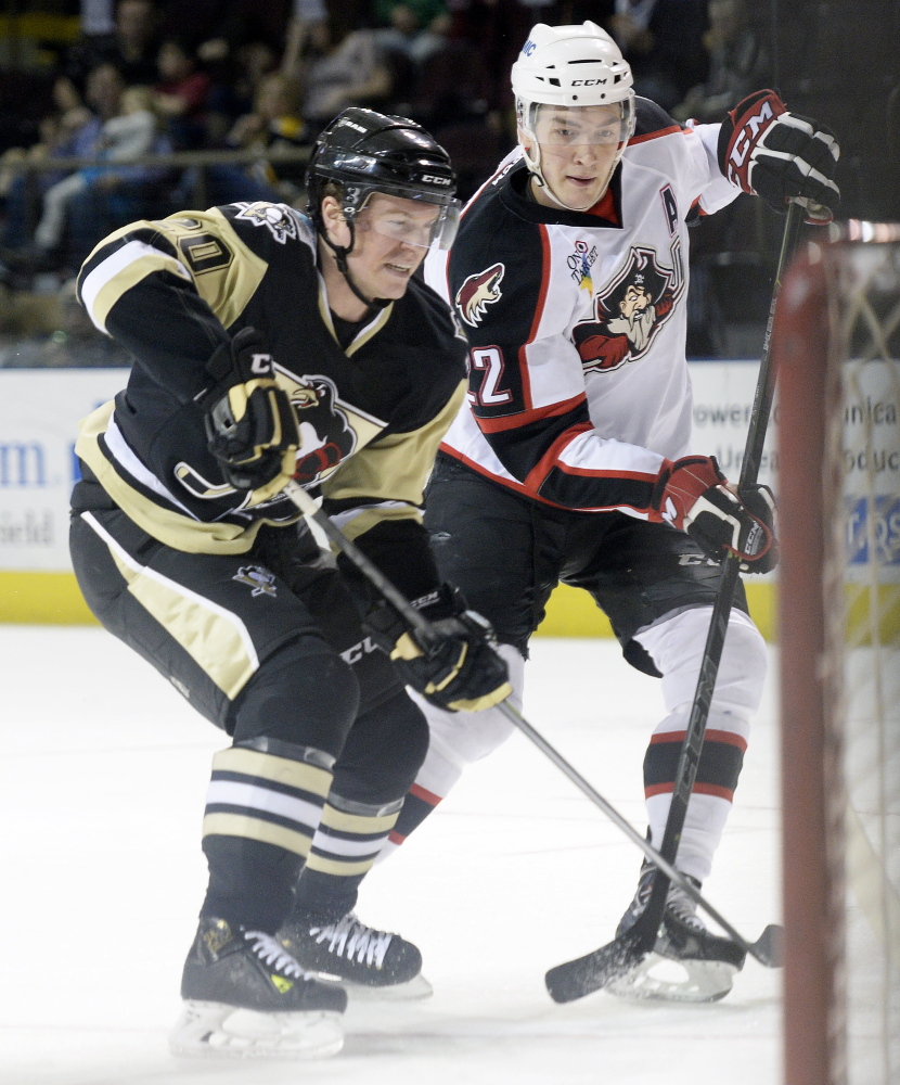 Wilkes-Barre/Scranton's Danny Syvret battles for position in front of the net with Portland's Phil Lane on Sunday. Shawn Patrick Ouellette/Staff Photographer