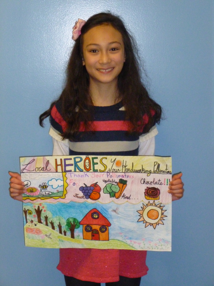 Lilly Curtis, a Hope Elementary School fifth-grader, poses with her winning poster submission for the Knox-Lincoln Soil & Water Conservation District’s stewardship-themed contest. The work will advance to the state level of competition.
