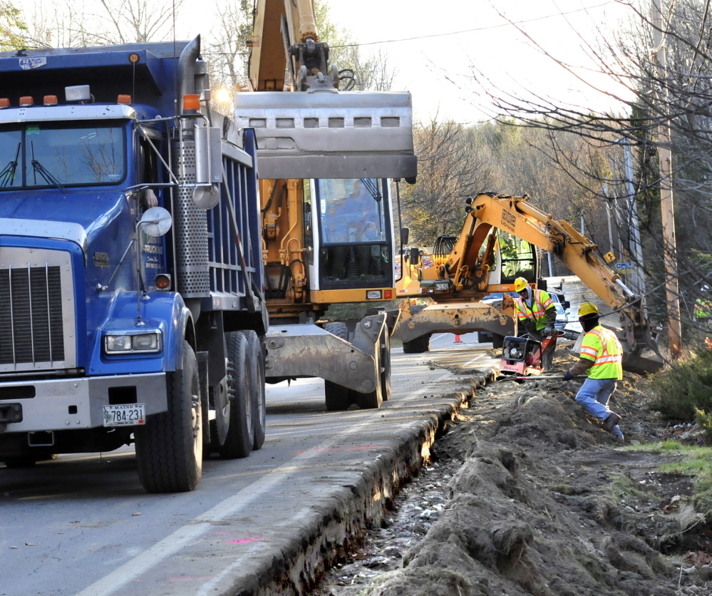 Subcontractors bury natural gas pipeline in Fairfield in November 2013. Summit will temporarily suspend service in the Waterville area to inspect equipment that may have been installed improperly.
