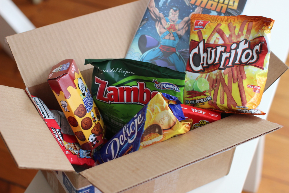 A Karepax box bundles offbeat snacks such as Japanese corn-flavored gummies or pig-shaped pound cake from Thailand with independent comic books.