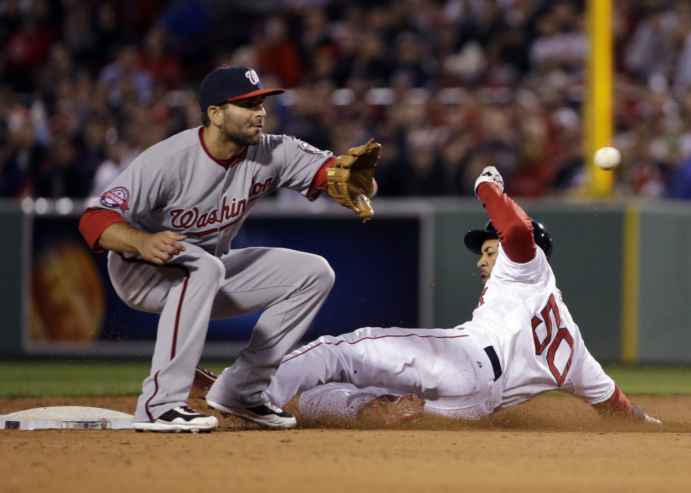 Boston’s Mookie Betts slides into second with a stolen base in the sixth inning Tuesday night as Washington Nationals second baseman Danny Espinosa takes the late throw. The Red Sox went on to an 8-7, come-from behind win.