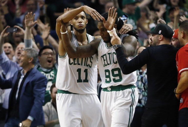 The Celtics’ Jae Crowder (99) celebrates his game-winning basket with teammate Evan Turner (11) during the final second of the fourth quarter Tuesday night. The Celtics locked up the No. 7 seed in the Eastern Conference playoffs with the win.