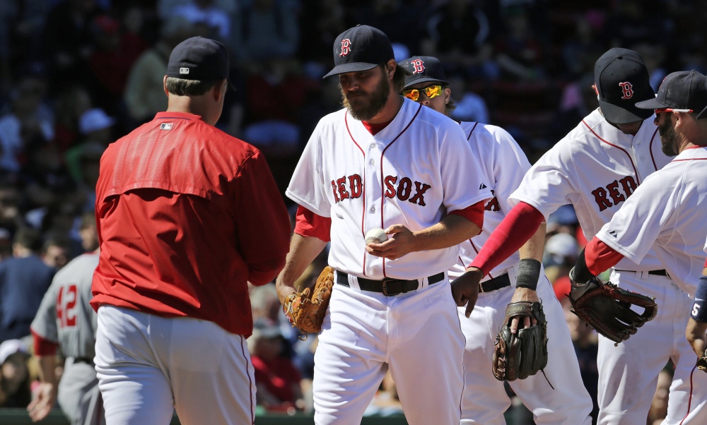 Red Sox starting pitcher Wade Miley hands the ball to manager John Farrell as he is taken out of the game after giving up a three-run double to Washington Nationals catcher Wilson Ramos during the third inning Wednesday at Fenway Park. Miley gave up seven earned runs in his short outing.