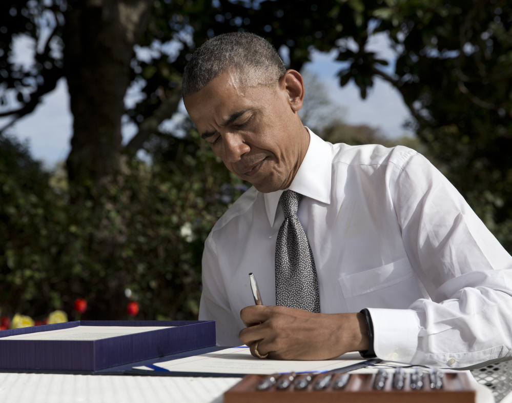 President Obama signs a new Medicare reimbursement bill in the Rose Garden of the White House on Thursday.