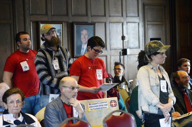 Portland residents wait in line to speak in favor of the minimum wage proposal at Portland City Hall on Thursday night. From left are Scott Kimball, Ryan Ferguson, Drew Christopher Joy and Meaghan LaSala.
Shawn Patrick Ouellette/Staff Photographer