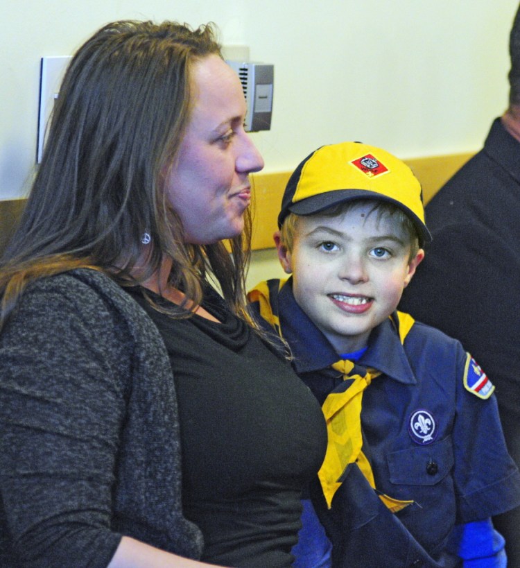 Melissa Burnham of East Dixfield and her son Noah listen to testimony during a hearing Thursday on a medical marijuana bill before the Legislature’s Education Committee. Burnham says she had to take Noah out of school recently because Maine law doesn’t allow him to take cannabis to school.