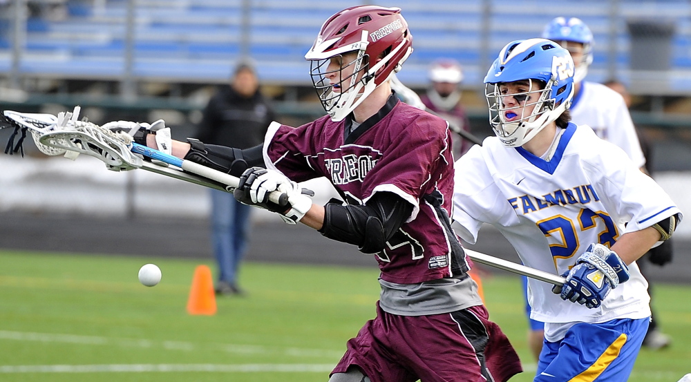 Seth Masciangelo of Falmouth, right, knocks the ball away from Matthew Roy of Freeport during Falmouth’s 22-2 victory Thursday in a schoolboy lacrosse opener at Falmouth.