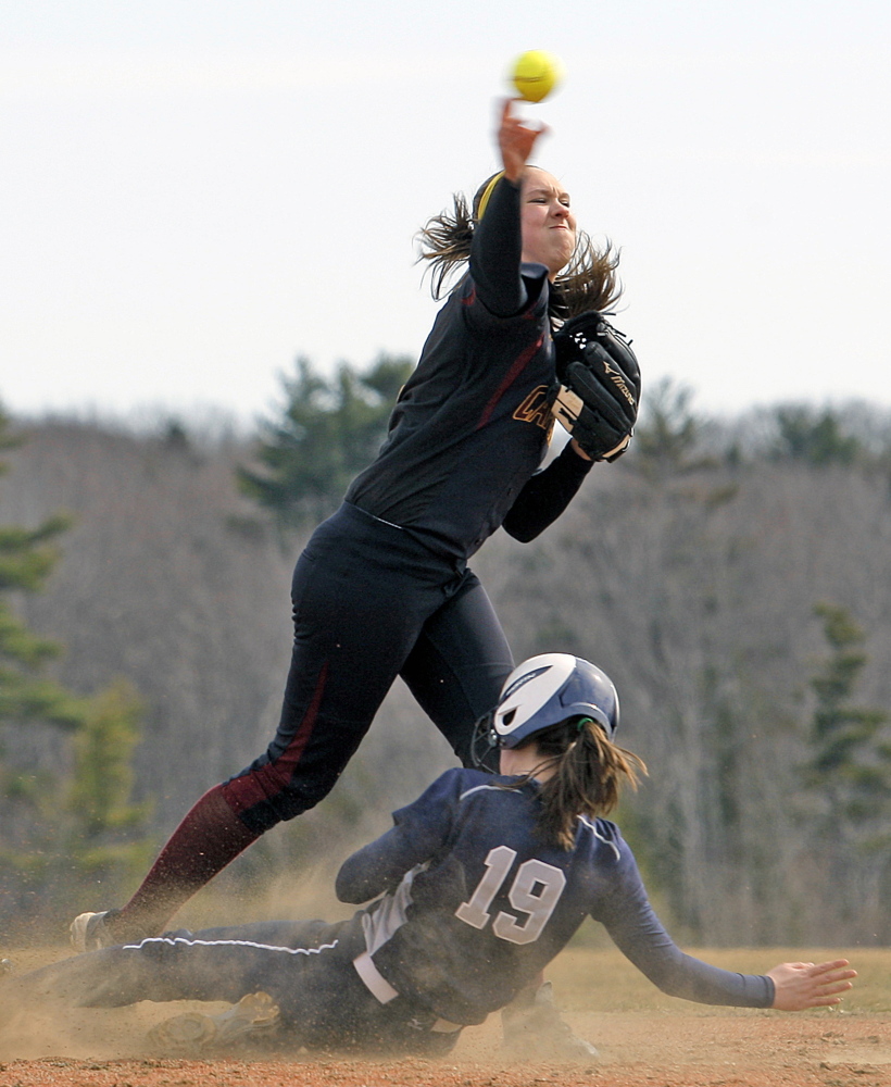 Tess Haller of Cape Elizabeth attempts to turn a double play as Sydney St. Pierre of Yarmouth slides into second base during an opening-day softball game.