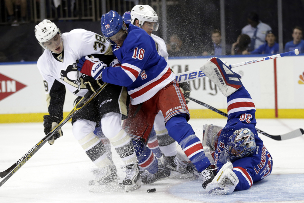 New York goaltender Henrik Lundqvist and defenseman Marc Staal defend the net against Pittsburgh Penguins left wing David Perron during the first period of Thursday’s playoff opener at Madison Square Garden.