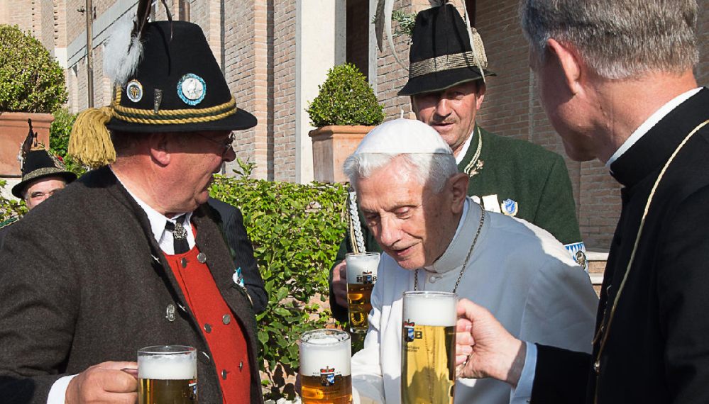 Pope Emeritus Benedict XVI toasts his 88th birthday Thursday with Monsignor Georg Gaenswein, right, and members of a group from his hometown region in Bavaria.