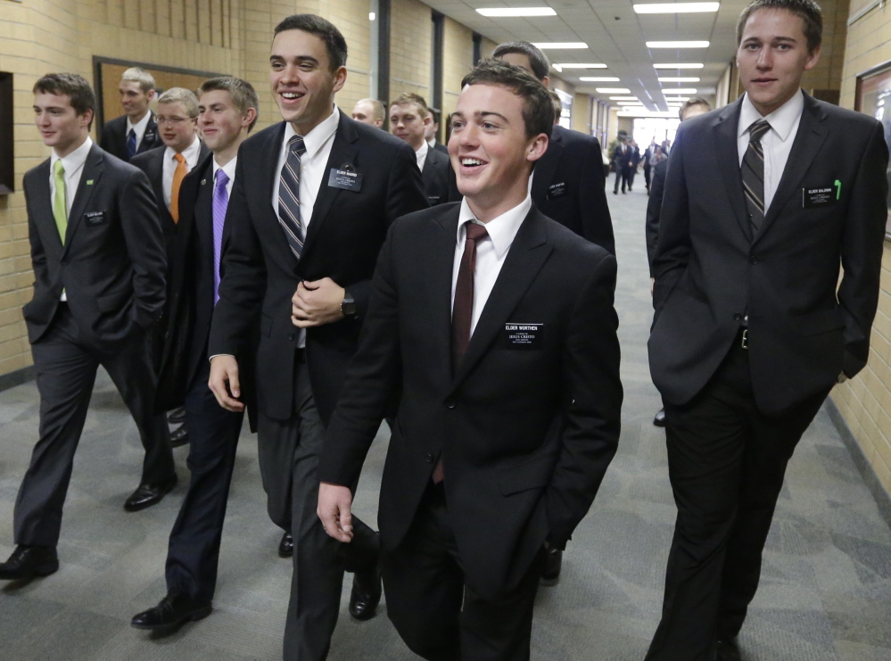 Mormon missionaries walk through the halls at the Missionary Training Center in Provo, Utah, in 2013. A record number of young Mormons signed up for missions after 2012.