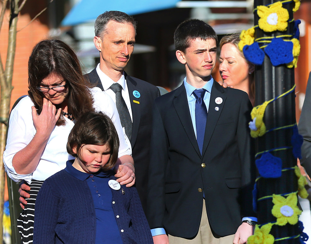 Boston Marathon bombing survivor Jane Richard, 9. left, and her brother Henry stand in front of their parents, Bill and Denise Richards, at a memorial honoring victims and survivors of the Boston Marathon bombing in Boston on Wednesday. The family lost one 8-year-old Martin in the attack on April 15, 2013.