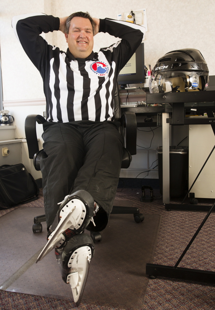 Joe Andrews wears his AHL officiating garb at his Portland office, where he works as an insurance adjuster. Andrews will officiate his last AHL hockey game Saturday night.