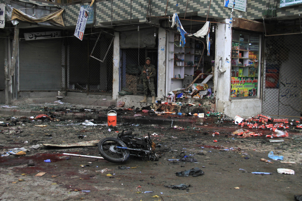 An Afghan security forces inspect at the site of suicide attack near to new Kabul Bank in Jalalabad east of Kabul, Afghanistan, Saturday, April, 18, 2015. A suicide bomb attack on a bank branch in the eastern Afghan city of Jalalabad has killed at least 30 people, officials said. Ahmad Zia Abdulzai, spokesman for the provincial governor in Nangarhar province, said on Saturday that more than 100 people were also wounded in the attack in Jalalabad, the provincial capital. (AP Photo)
