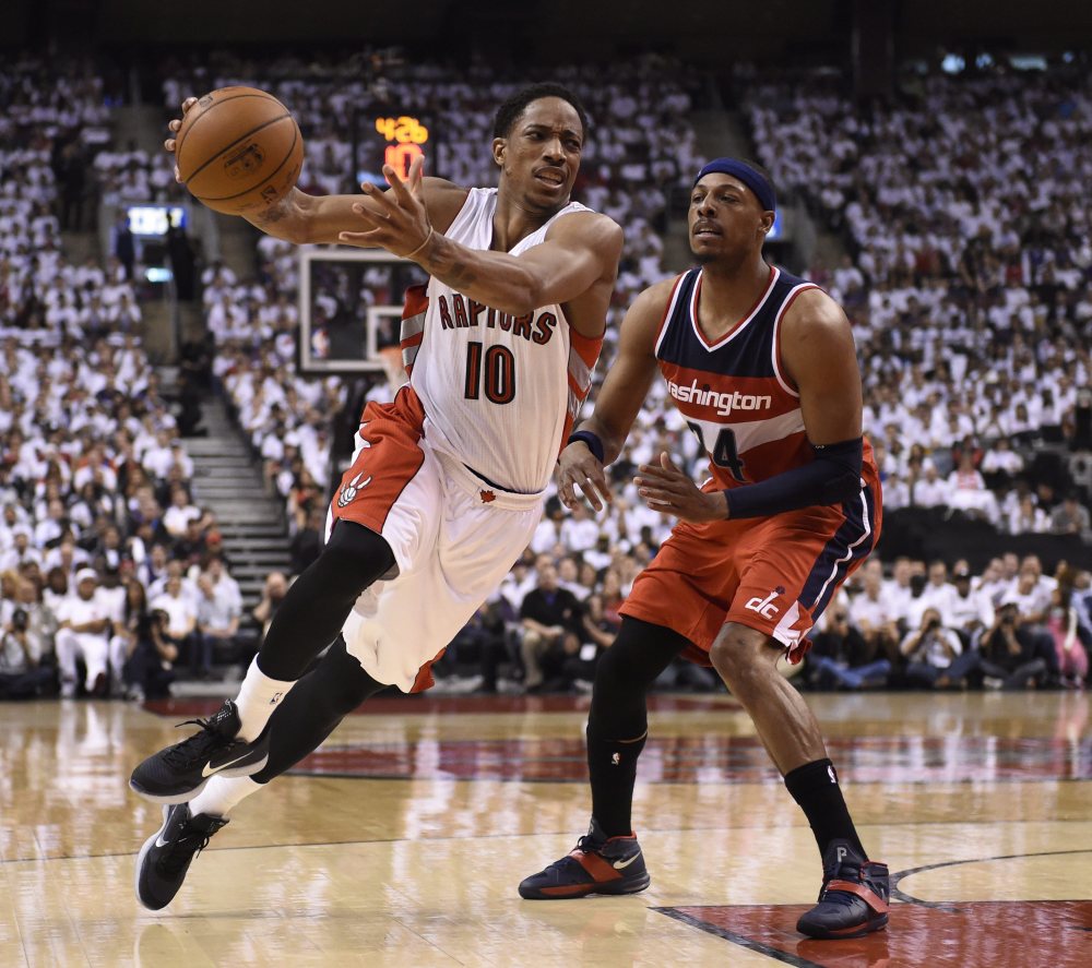 DeMar DeRozan of the Raptors is fouled by Washington’s Paul Pierce in first half Saturday in Game 1 of their playoff series at Toronto. The Wizards won in overtime, 93-86.