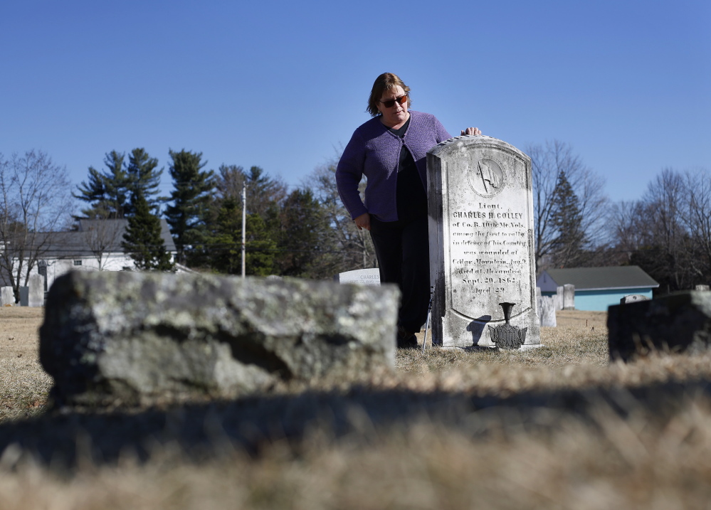 Debi Curry, an employee of the town of Gray and member of the historical society, stands by the memorial for Union soldier Charles Colley.