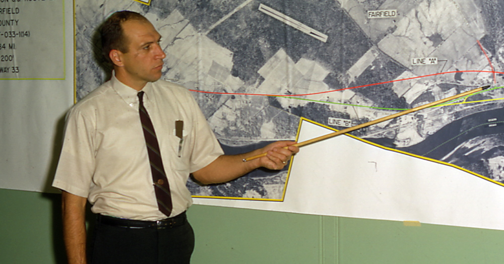 Richard Coleman of Augusta points to a map this 1968 photo provided by the Maine Department of Transportation. He has had a hand in many major construction projects over the years, prompting the Legislature to name I-295 after him.
