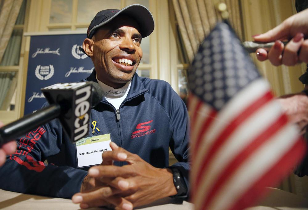 Long distance runner Meb Keflezighi talks with reporters during a news conference, Friday in Boston. The 119th Boston Marathon will be run Monday. The Associated Press